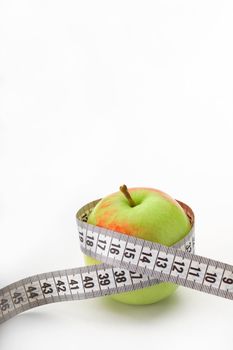 Apple with a measuring tape on white