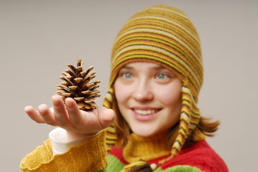 Girl in yellow cap with fir apple 