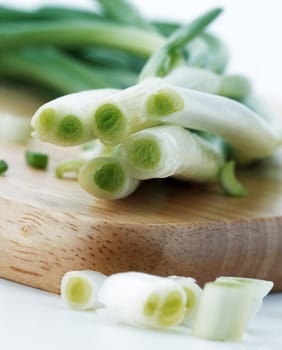 Bunch of green onions on a cutting board