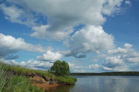 Greater river of Russia Volga in the afternoon under the blue sky with clouds