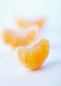 Slices of a ripe tangerines on a white background