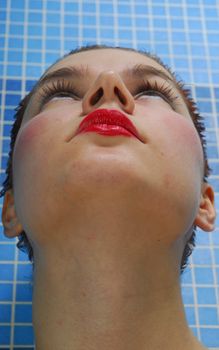 The girl with graceful neck on a blue background