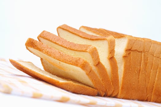 Sliced white bread for toasts on white background.