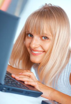 Close-up portrait of a woman with laptop