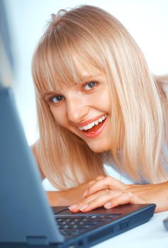 Close-up portrait of a woman with laptop