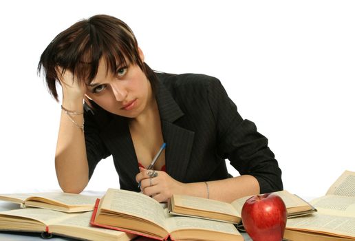 The young girl with books and a red apple, isolated on white