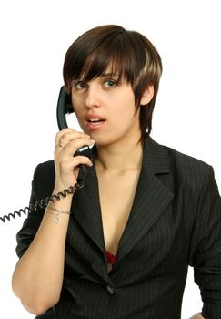 The young nice girl speaks by phone, isolated on white