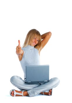 Smiling woman sitting with her legs crossed on the floor with laptop