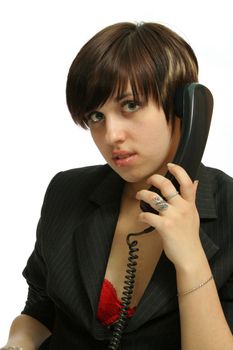 The young nice girl speaks by phone, isolated on white