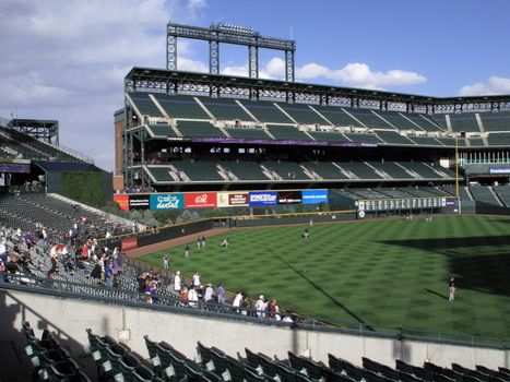 Fans watch batting practice at the home field of Colorado Rockies, located in downtown Denver