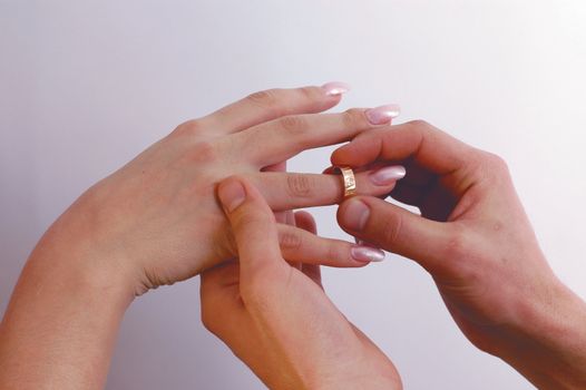 Man put on a wedding ring to the woman's hand