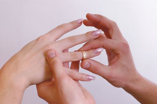 Man put on a wedding ring to the woman's hand
