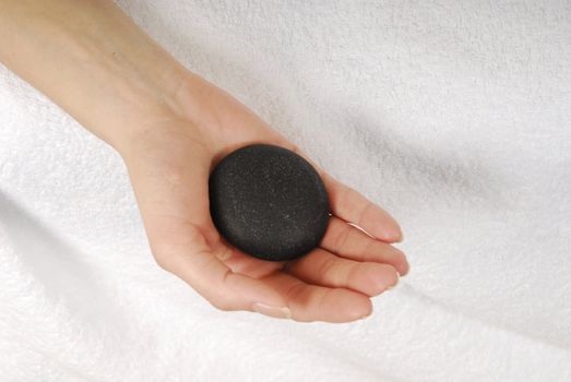 Woman hand with gray stone