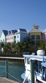 Taken from the ferry port in Nassau along the ocean side, featuring multicoloured houses against a blue sky