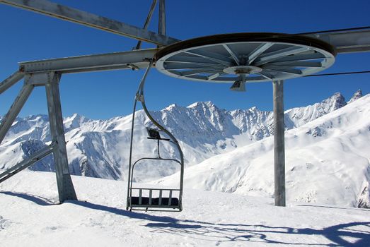 Photo of a typical empty ski gondola with a scenic background