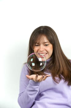 Pretty woman blowing in the soap to create some bubbles