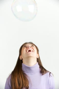 Pretty woman blowing in the soap to create some bubbles