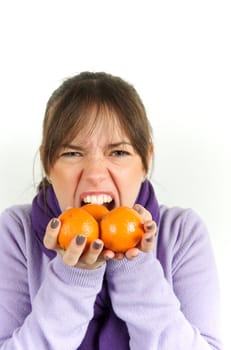 Pretty woman playing with orange fruit