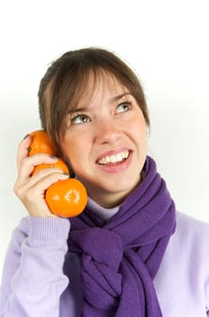 Pretty woman playing with orange fruit