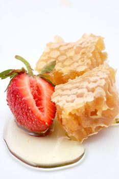 Piece of honey and strawberry isolated
