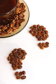 Cup of coffee and footprint from coffee beans 