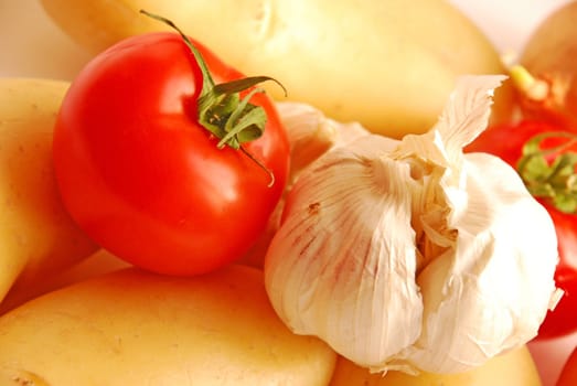 Close up of garlic, tomato, potatoes and onion