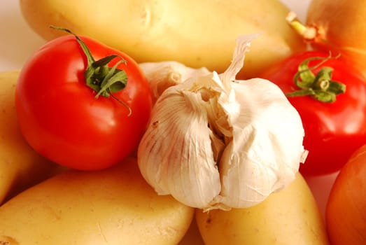 Close up of garlic, tomato, potatoes and onion