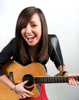 Pretty woman playing with guitar