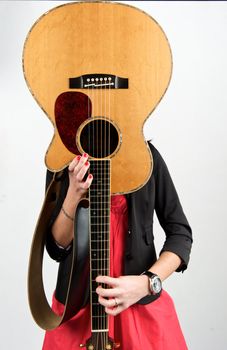 Pretty woman playing with guitar