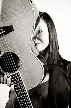 Pretty woman playing with guitar