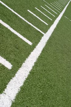 Green football field with large yard markers.