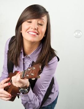 Pretty woman playing with guitar