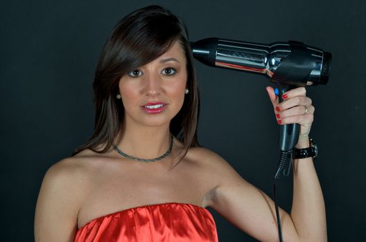 Young attractive woman with hairdryer 