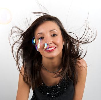 Pretty young woman posing with some bubbles around her