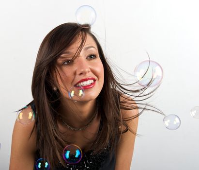 Pretty young woman posing with some bubbles around her