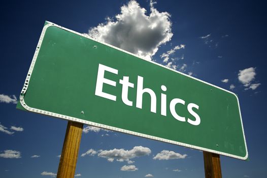 Ethics road sign with dramatic blue sky and clouds.