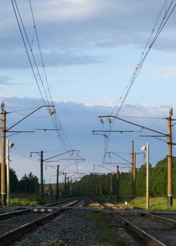 Straight railway track in summer sunrise