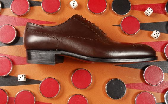 Man's shoe on the backgammon board