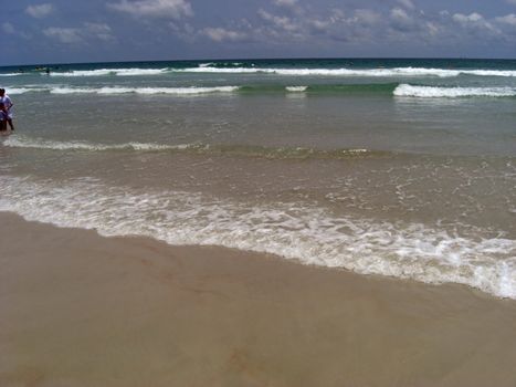 A pristine ocean in Ponce Inlet is gently flowing out to the clean beach.