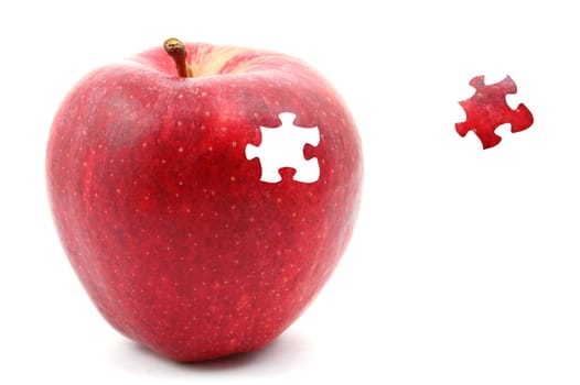 apple with a puzzle piece isolated on white background