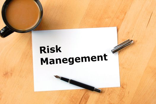 risk management concept with pen paper and coffee in office