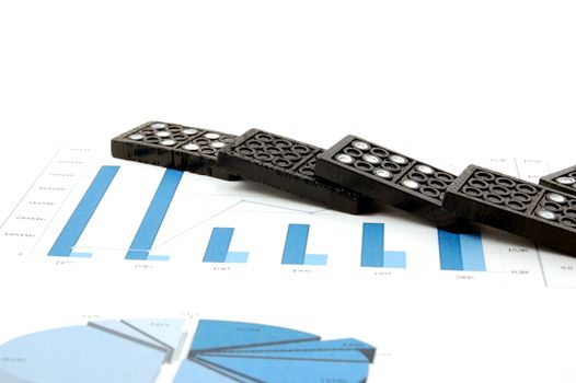 some domino stones on a blue business chart