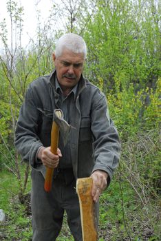 Man with axe on the nature 