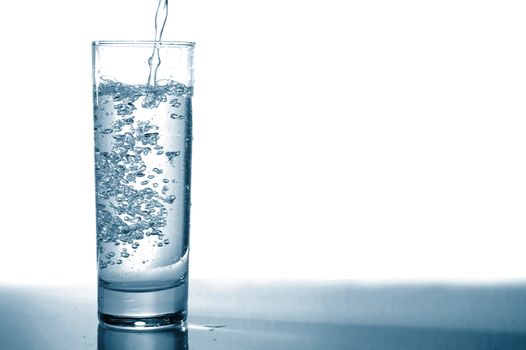 glass of pouring fresh and cold water