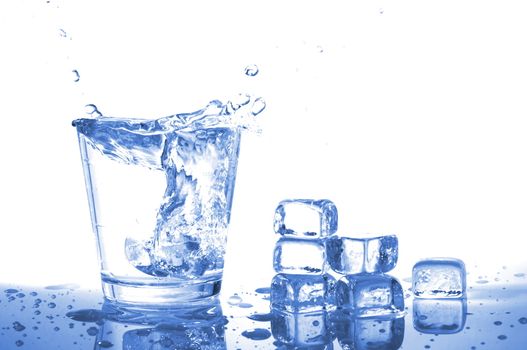 glass of ice water with bubbles on white background