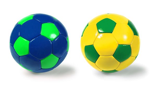 Photograph of two isolated soccer balls - different colour combinations.  Clipping paths included.
