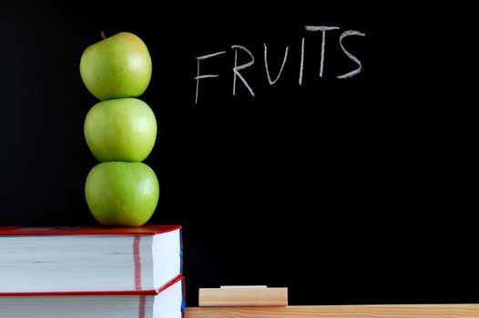 apples books and chalkboard showing healthy lifestyle