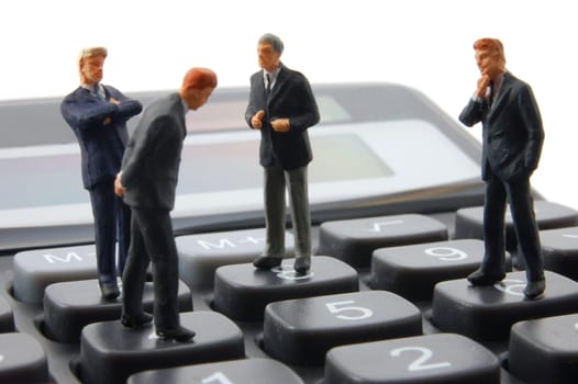 toy business man on calculator isolated on white background