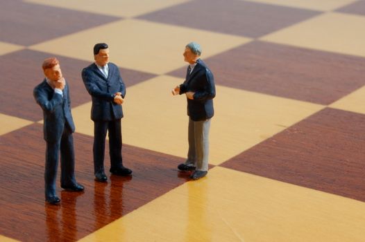 group uf business people standing on a chess board