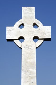 White Grave Stone Cross In Front Of Clear Blue Sky
